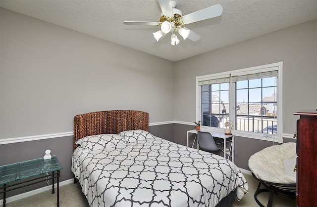 1325 SE Florence Dr Unit 211, Waukee, IA 50263 - carpeted bedroom with baseboards, ceiling fan, and a textured ceiling
