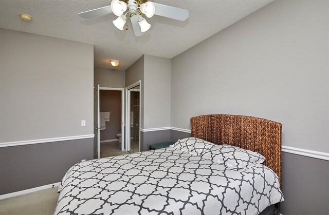 1325 SE Florence Dr Unit 211, Waukee, IA 50263 - bedroom featuring carpet, baseboards, a ceiling fan, and a textured ceiling