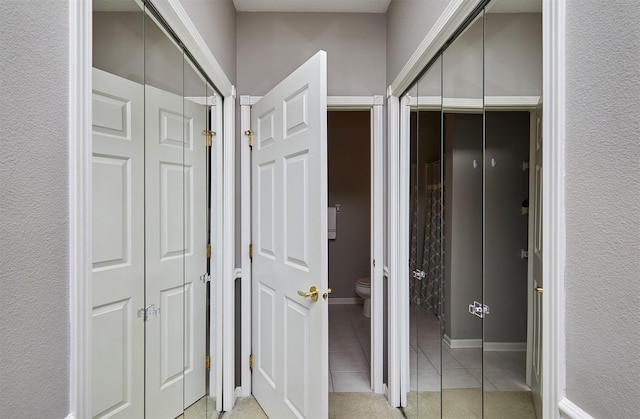 1325 SE Florence Dr Unit 211, Waukee, IA 50263 - bathroom featuring a closet, toilet, and tile patterned flooring
