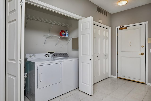1325 SE Florence Dr Unit 211, Waukee, IA 50263 - laundry room featuring laundry area, light tile patterned floors, visible vents, and washer and clothes dryer