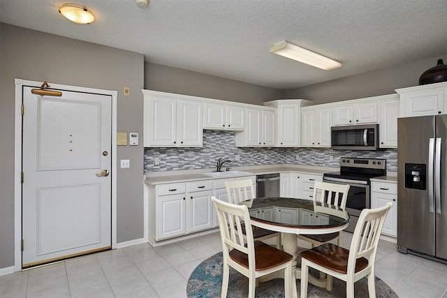 1325 SE Florence Dr Unit 211, Waukee, IA 50263 - kitchen with tasteful backsplash, light tile patterned floors, light countertops, stainless steel appliances, and a sink