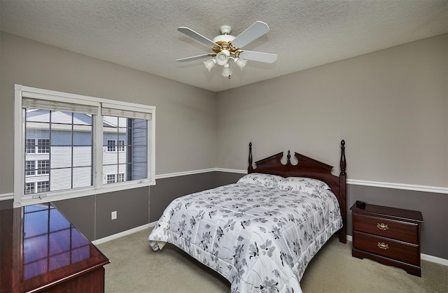 1325 SE Florence Dr Unit 211, Waukee, IA 50263 - bedroom with a textured ceiling, ceiling fan, baseboards, and carpet