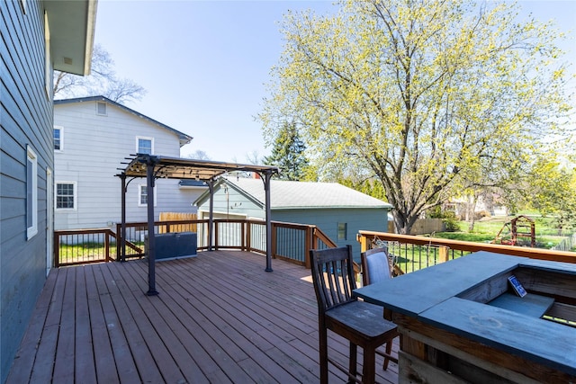 deck featuring fence and a pergola