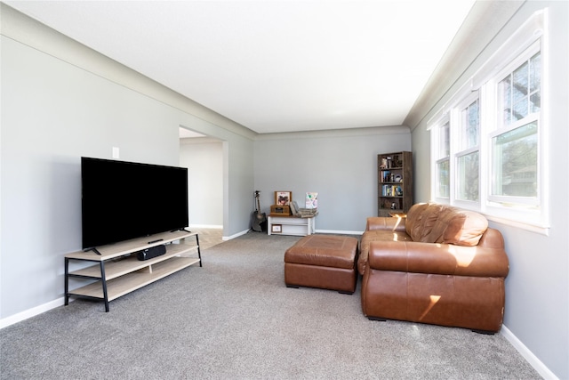 carpeted living area featuring baseboards