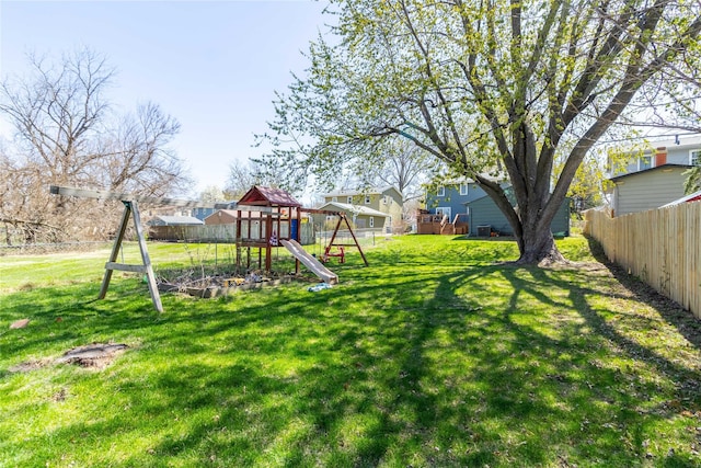 view of yard featuring fence and a playground