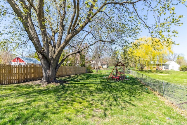 view of yard featuring a fenced backyard and a playground
