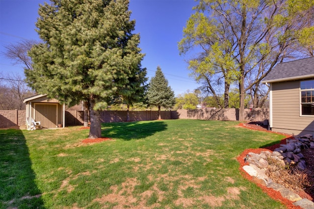 5570 Sunburst Dr, Pleasant Hill, IA 50327 - view of yard featuring an outbuilding, a fenced backyard, and a storage unit