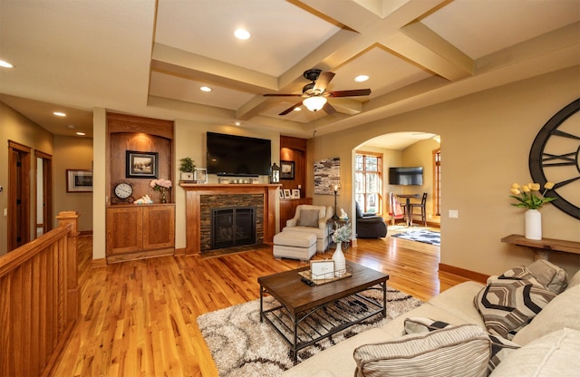 5570 Sunburst Dr, Pleasant Hill, IA 50327 - living room featuring ceiling fan, a fireplace, arched walkways, light wood-type flooring, and coffered ceiling