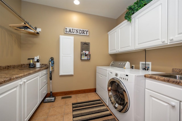 5570 Sunburst Dr, Pleasant Hill, IA 50327 - clothes washing area featuring light tile patterned floors, visible vents, washing machine and clothes dryer, baseboards, and cabinet space