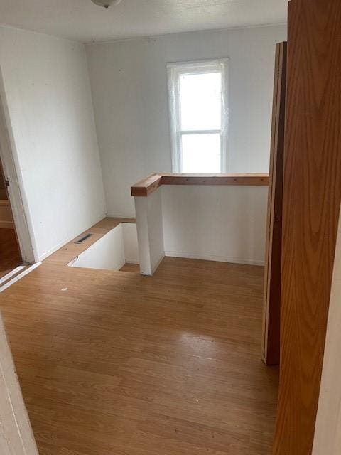 unfurnished room featuring visible vents and light wood-type flooring