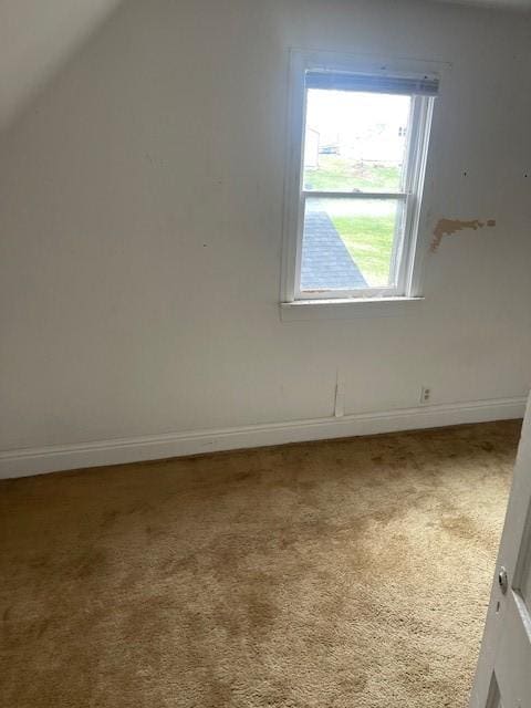 bonus room with baseboards, carpet, and vaulted ceiling
