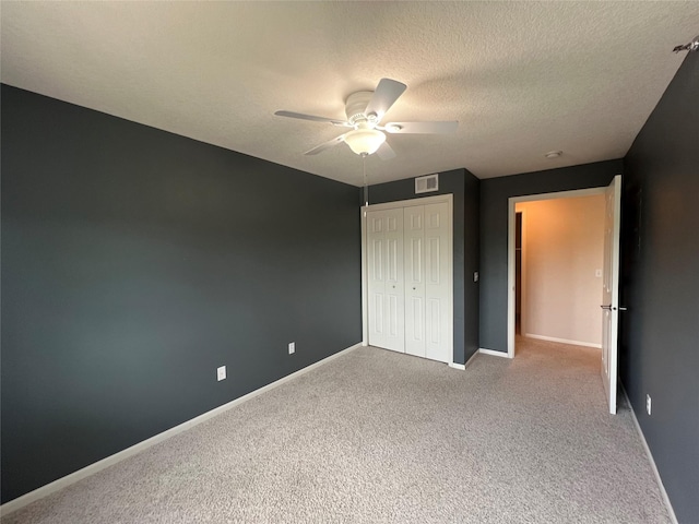 6440 Ep True Pkwy Unit 2307, West Des Moines, IA 50266 - unfurnished bedroom with carpet, a closet, a textured ceiling, and ceiling fan