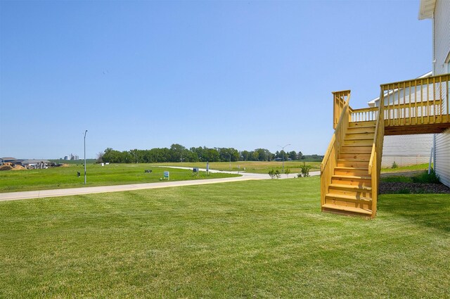 1139 NW Petersen Dr, Waukee, IA 50263 - view of grassy yard with stairs and a wooden deck