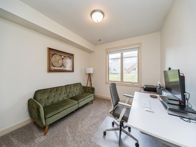 carpeted office featuring visible vents and baseboards