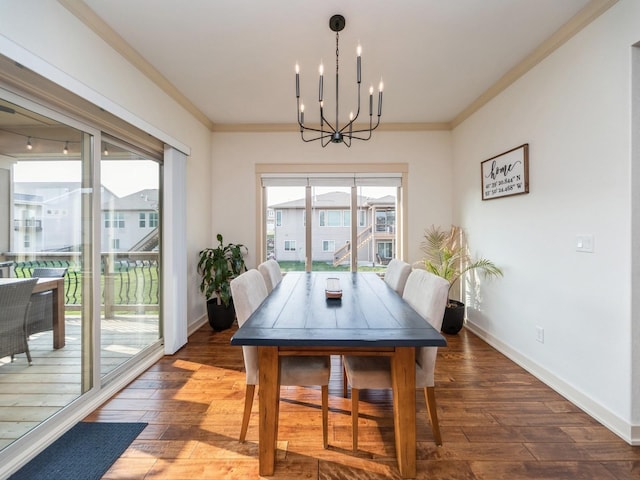 dining space with baseboards, an inviting chandelier, ornamental molding, and wood-type flooring