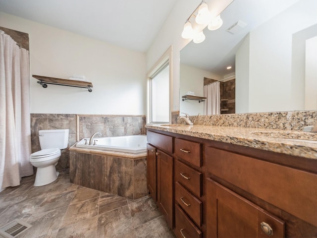 bathroom with toilet, a garden tub, visible vents, and a sink