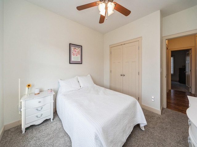 carpeted bedroom featuring baseboards, a ceiling fan, and a closet