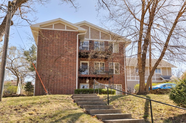 5322 Ingersoll Ave Unit B5, Des Moines, IA 50312 - view of front of home featuring brick siding, stairway, a balcony, and a front yard