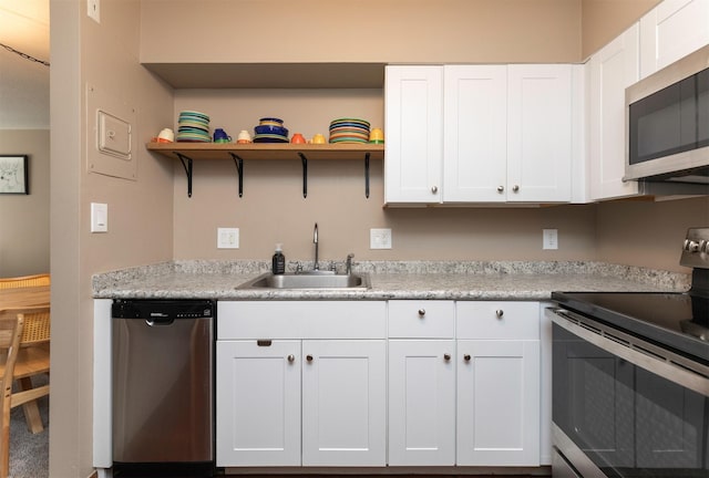 5322 Ingersoll Ave Unit B5, Des Moines, IA 50312 - kitchen with appliances with stainless steel finishes, white cabinets, light countertops, and open shelves