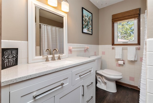 5322 Ingersoll Ave Unit B5, Des Moines, IA 50312 - full bathroom featuring wood finished floors, vanity, tile walls, and wainscoting