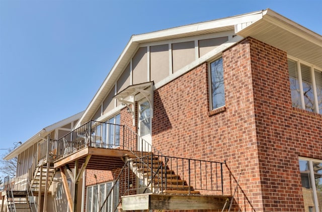 5322 Ingersoll Ave Unit B5, Des Moines, IA 50312 - view of property exterior featuring stairs, brick siding, and a deck