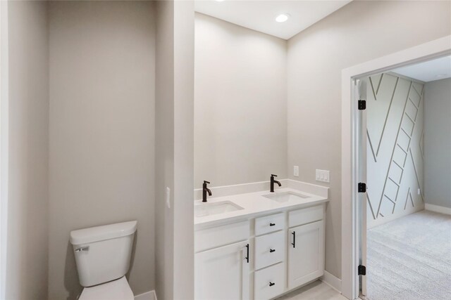 304 13th St NW, Bondurant, IA 50035 - bathroom featuring toilet, double vanity, and baseboards