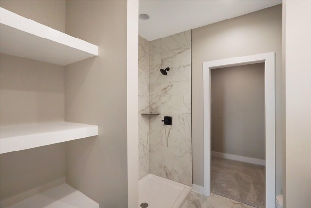 304 13th St NW, Bondurant, IA 50035 - full bathroom featuring a stall shower, marble finish flooring, baseboards, and toilet