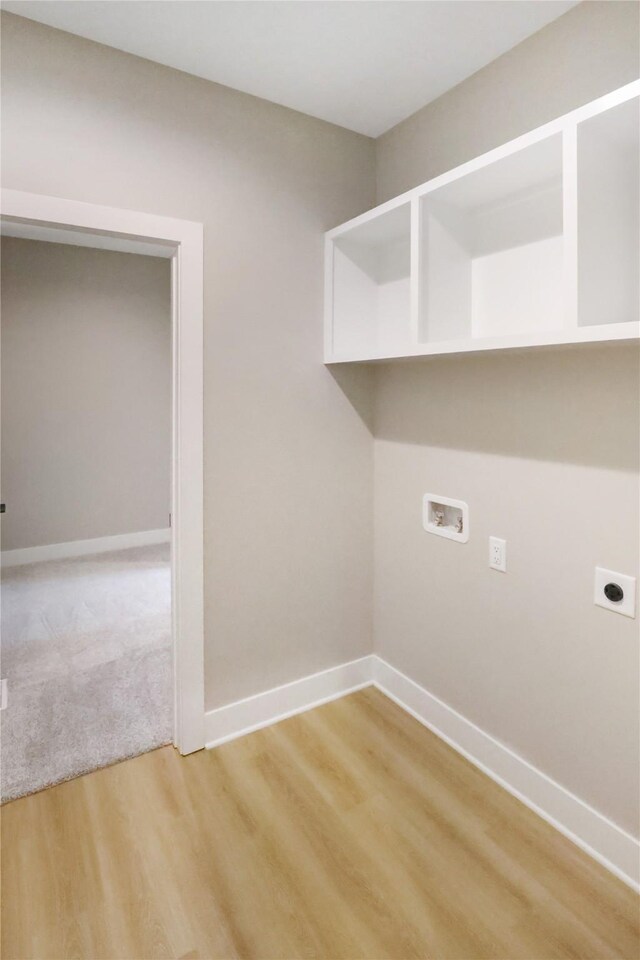 304 13th St NW, Bondurant, IA 50035 - laundry area with hookup for an electric dryer, hookup for a washing machine, light wood finished floors, and baseboards