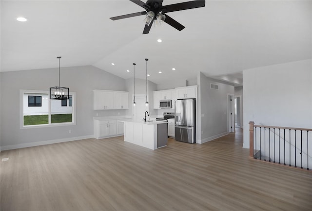 304 13th St NW, Bondurant, IA 50035 - kitchen with stainless steel appliances, open floor plan, a kitchen island with sink, light wood-style flooring, and recessed lighting