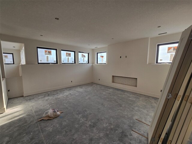 4611 Centennial Blvd, Urbandale, IA 50323 - empty room featuring a textured ceiling and baseboards