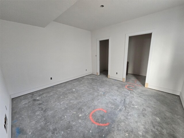4611 Centennial Blvd, Urbandale, IA 50323 - unfurnished bedroom featuring unfinished concrete flooring and baseboards