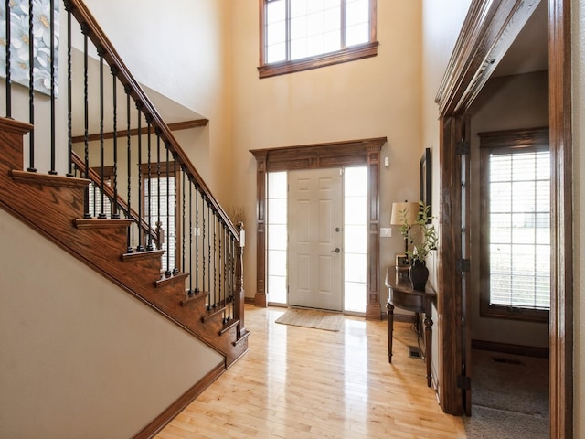 1835 SE Hillside Dr, Ankeny, IA 50021 - foyer entrance featuring light wood-style flooring, stairway, and a high ceiling