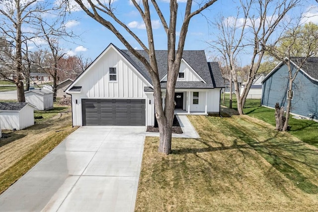 modern farmhouse style home featuring board and batten siding, driveway, roof with shingles, a front yard, and a garage