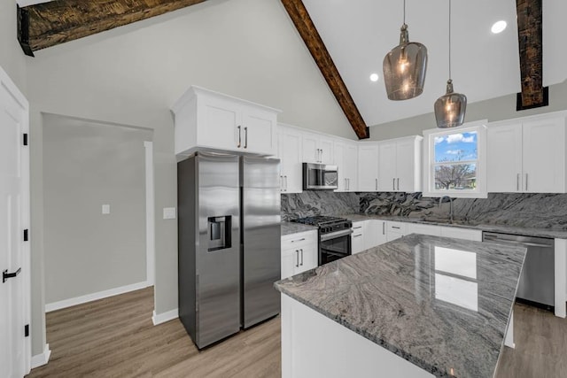 kitchen with light stone counters, backsplash, beamed ceiling, light wood-type flooring, and appliances with stainless steel finishes
