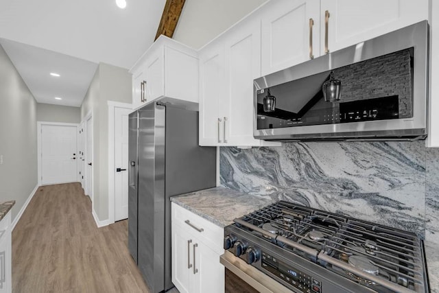 kitchen featuring appliances with stainless steel finishes, tasteful backsplash, white cabinetry, and light wood-type flooring