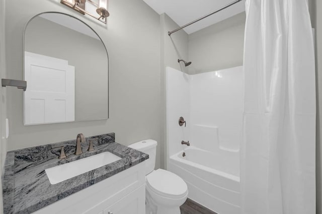 bathroom featuring shower / tub combo with curtain, toilet, and vanity