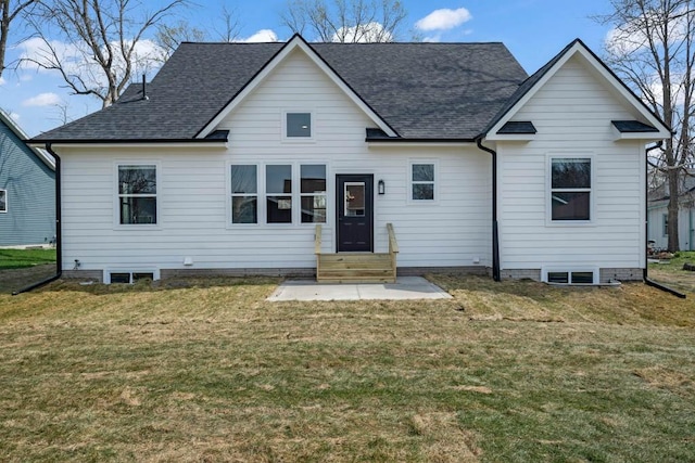rear view of house featuring a lawn, a shingled roof, and entry steps