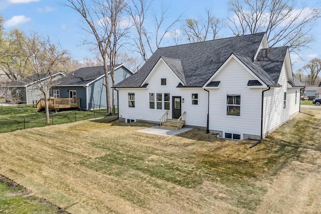 back of property featuring a lawn, roof with shingles, and entry steps