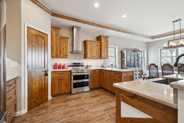 kitchen featuring recessed lighting, wall chimney range hood, dark wood-style floors, and range with two ovens