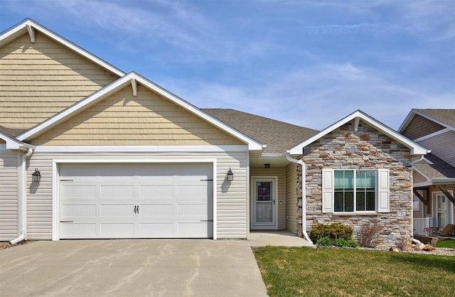 view of front of house with a front lawn, an attached garage, driveway, stone siding, and roof with shingles
