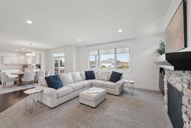 3667 NW 165th St, Clive, IA 50325 - living area with recessed lighting, baseboards, a fireplace, and wood finished floors