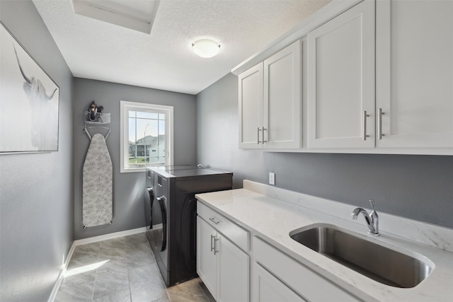 3667 NW 165th St, Clive, IA 50325 - laundry area with cabinet space, light marble finish flooring, washing machine and dryer, a textured ceiling, and baseboards