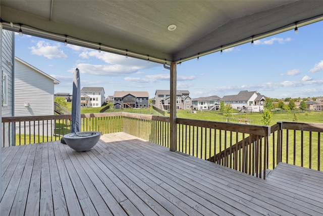 deck featuring a residential view and a yard