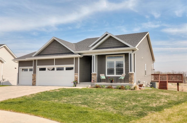 172 Crossroads Dr, Des Moines, IA 50320 - craftsman inspired home featuring an attached garage, covered porch, a front yard, driveway, and stone siding