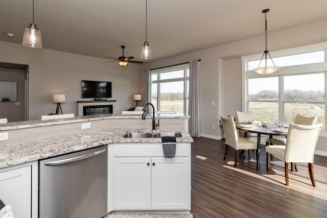 172 Crossroads Dr, Des Moines, IA 50320 - kitchen featuring stainless steel dishwasher, a sink, ceiling fan, dark wood-style floors, and white cabinetry