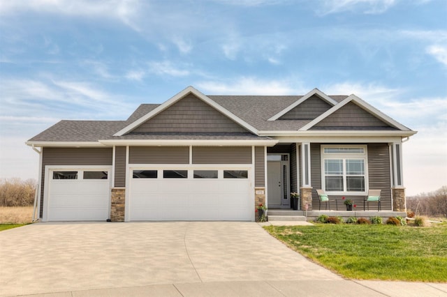 172 Crossroads Dr, Des Moines, IA 50320 - craftsman-style home featuring an attached garage, a porch, a shingled roof, and driveway