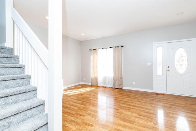 entrance foyer with recessed lighting, baseboards, stairs, and light wood-style flooring