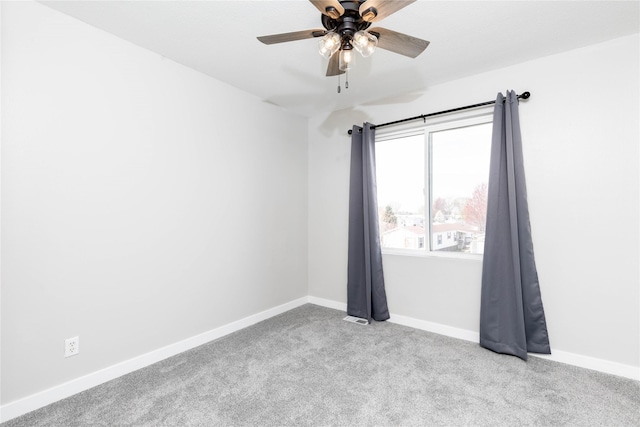 carpeted empty room with baseboards and ceiling fan