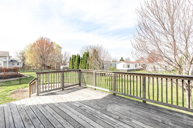 wooden terrace with a fenced backyard, a yard, and a residential view