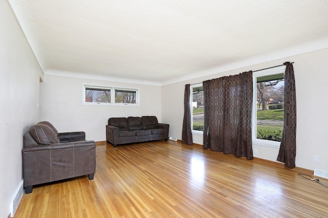 7422 Oak Brook Dr, Urbandale, IA 50322 - living room with baseboards, a wealth of natural light, and light wood-type flooring